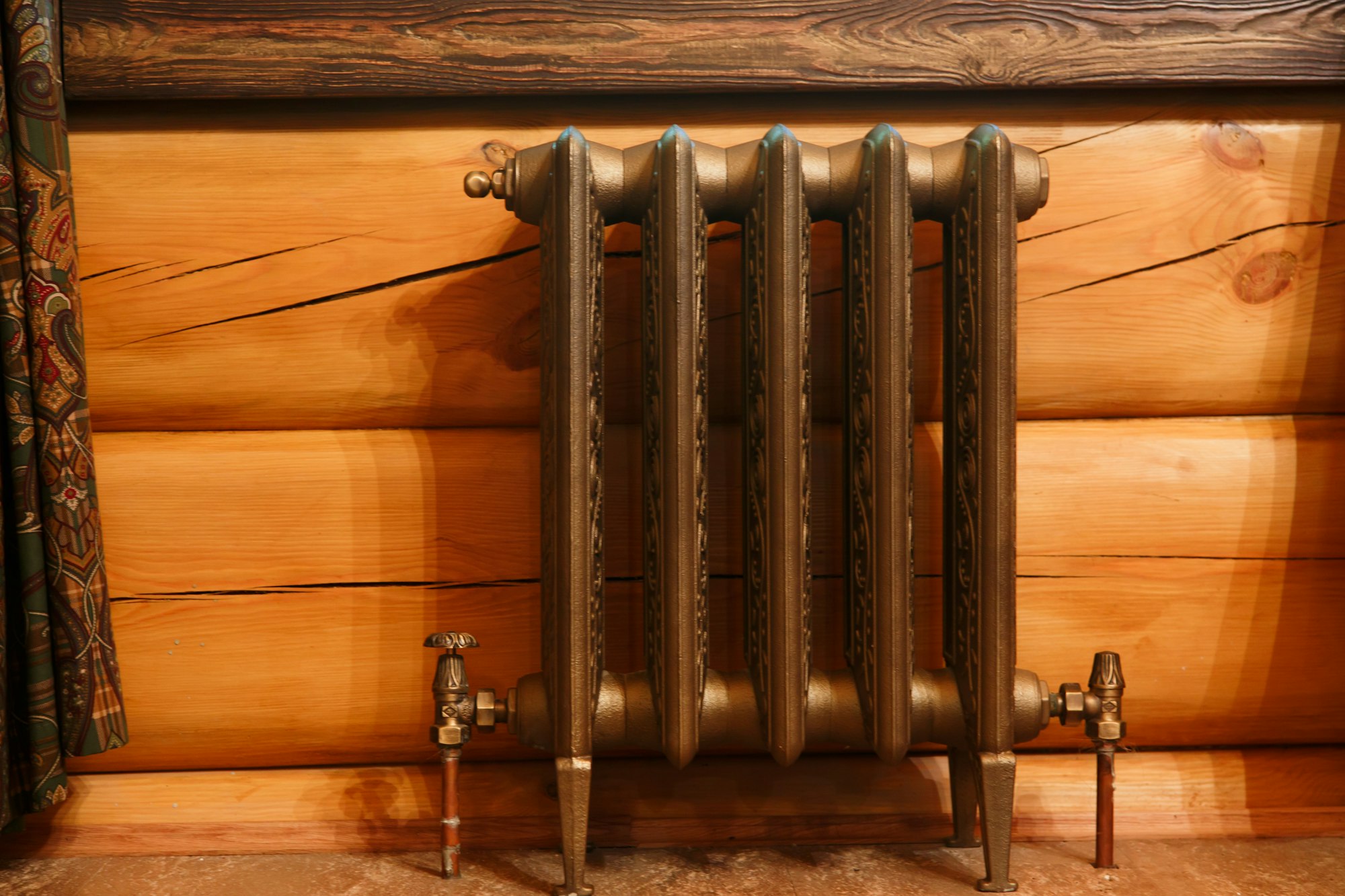 Cast iron retro design radiator in timber house.